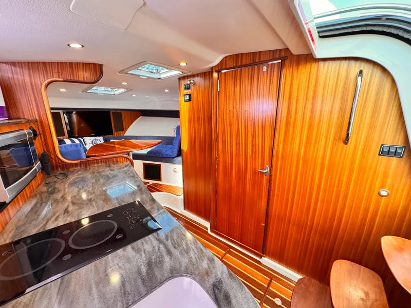 Slide: The Image of Luxurious interior of 2014 Pursuit OS 385 Offshore boat with wood finishes and modern amenities. - 17