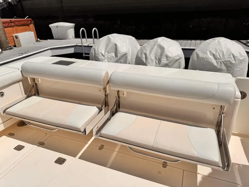 Slide: The Image of 2014 Pursuit OS 385 Offshore boat with foldable seating and covered engines. - 23