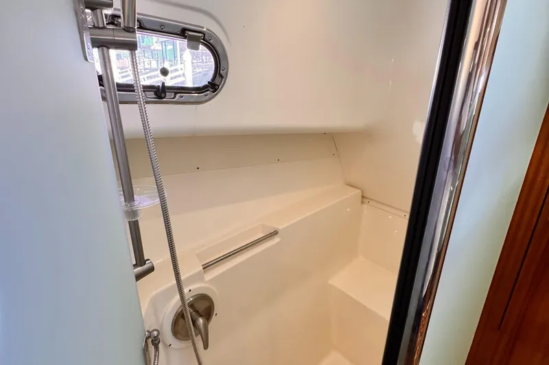 Slide: The Image of 2014 Pursuit OS 385 Offshore boat shower with sleek design and chrome fixtures. - 26