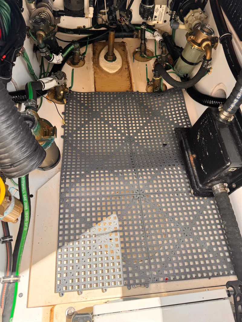 Slide: The Image of Engine compartment of a 2014 Pursuit OS 385 Offshore boat, showing mechanical components and wiring. - 32