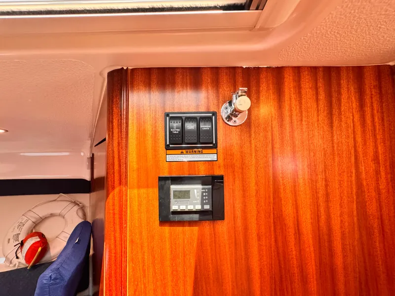 Slide: The Image of 2014 Pursuit OS 385 Offshore interior with control panel on wooden wall. - 9
