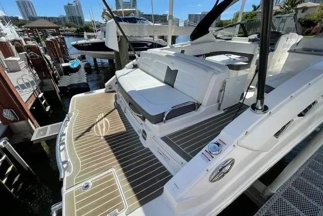 Slide: The Image of 2014 Chaparral 307 SSX boat docked, featuring spacious seating and sleek design. - 4