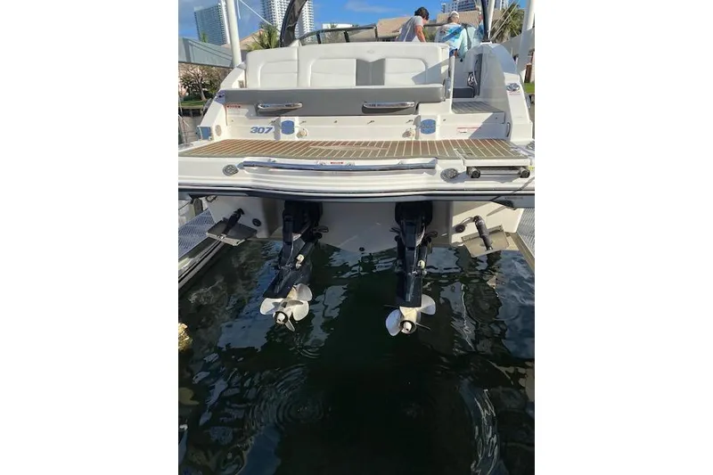 Slide: The Image of 2014 Chaparral 307 SSX boat stern view with dual propellers in marina. - 7