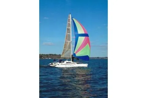 Slide: The Image of Sailboat Corsair F24 MKI 1994 with colorful spinnaker on open water. - 3