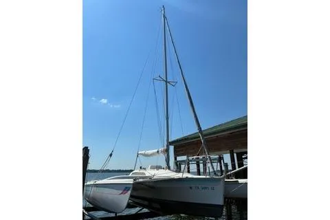 Slide: The Image of Sailboat Corsair F24 MKI 1994 docked under clear blue sky. - 4