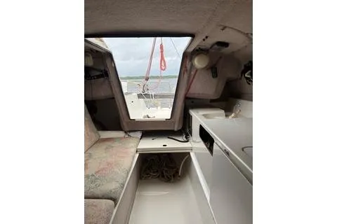 Slide: The Image of Interior of 1994 Corsair F24 MKI sailboat with seating and compact kitchenette. - 5