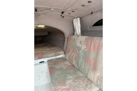 Slide: The Image of Interior of 1994 Corsair F24 MKI sailboat with patterned seating and compact cabin space. - 6