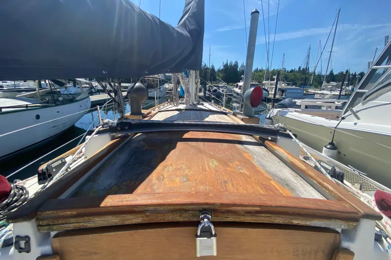 Slide: The Image of 1980 Pacific Seacraft Orion 27 sailboat docked at marina under clear blue sky. - 12