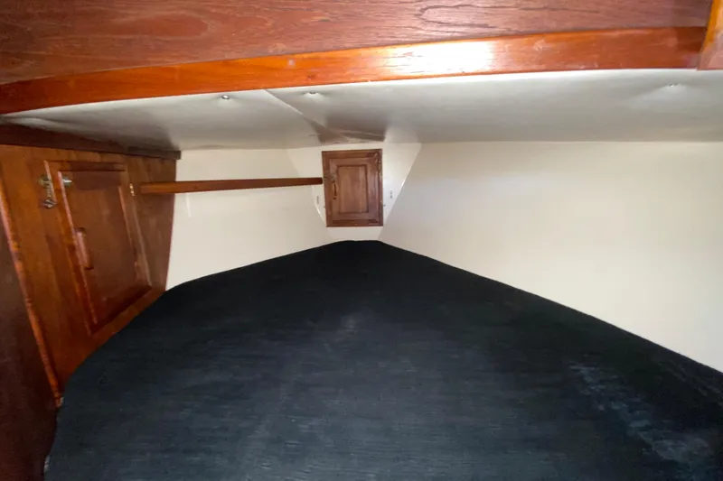 Slide: The Image of Cozy cabin interior of 1980 Pacific Seacraft Orion 27 sailboat with wooden accents. - 19