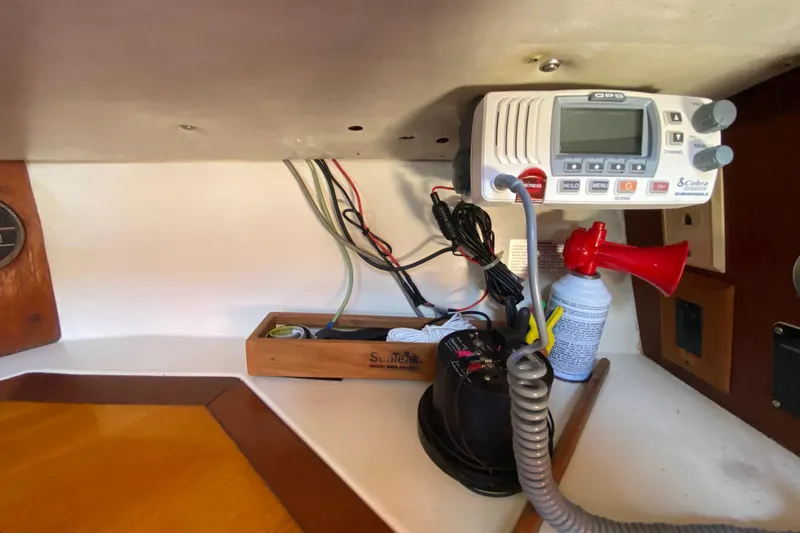 Slide: The Image of Interior of 1980 Pacific Seacraft Orion 27 with radio equipment and air horn. - 27