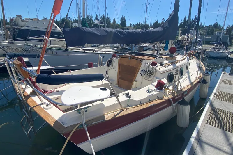 Slide: The Image of 1980 Pacific Seacraft Orion 27 sailboat docked at marina under clear blue sky. - 4