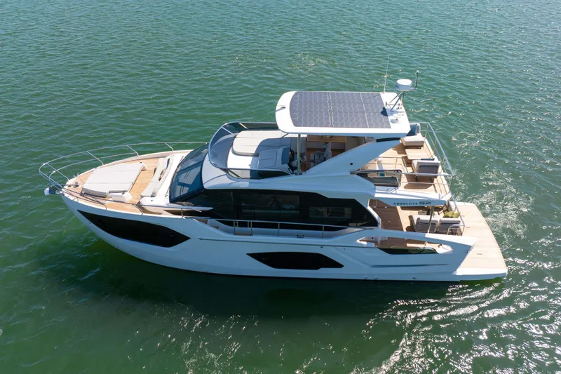 Slide: The Image of 2026 Absolute 52 Fly yacht cruising on open water, showcasing sleek design and spacious deck. - 57