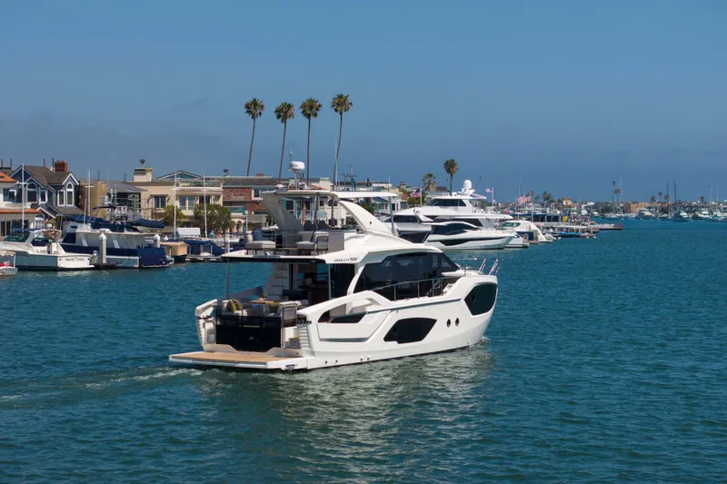 Slide: The Image of Luxury yacht Absolute 52 Fly 2026 cruising in a scenic marina setting. - 58