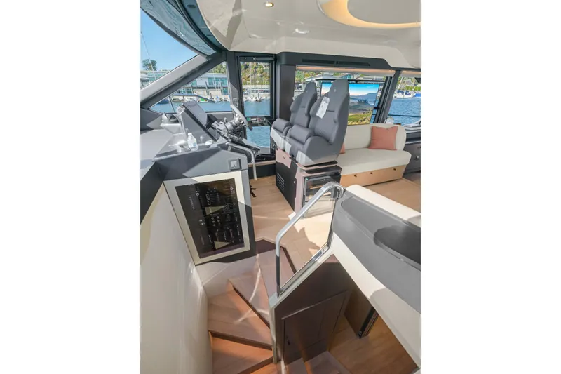 Slide: The Image of Interior of 2026 Absolute 52 Fly yacht, featuring modern helm and seating area. - 31