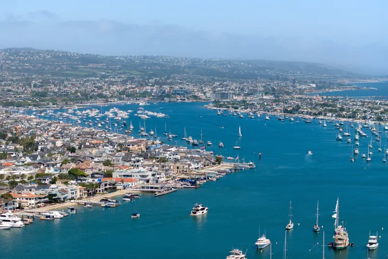 Slide: The Image of Aerial view of a bustling marina with numerous boats, featuring the Absolute 52 Fly, 2026 model. - 62
