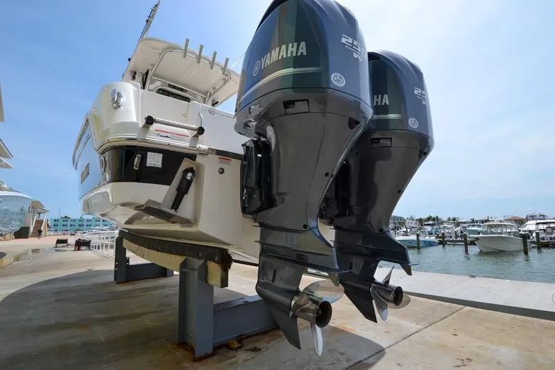 Slide: The Image of 2013 Robalo R260 Center Console with Yamaha engines at the marina. - 21
