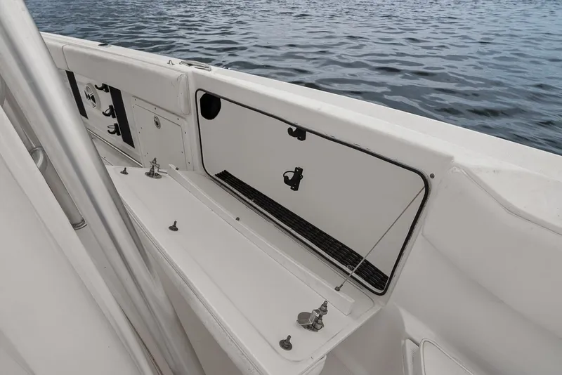 Slide: The Image of 2013 Robalo R260 Center Console boat deck by the water. - 24