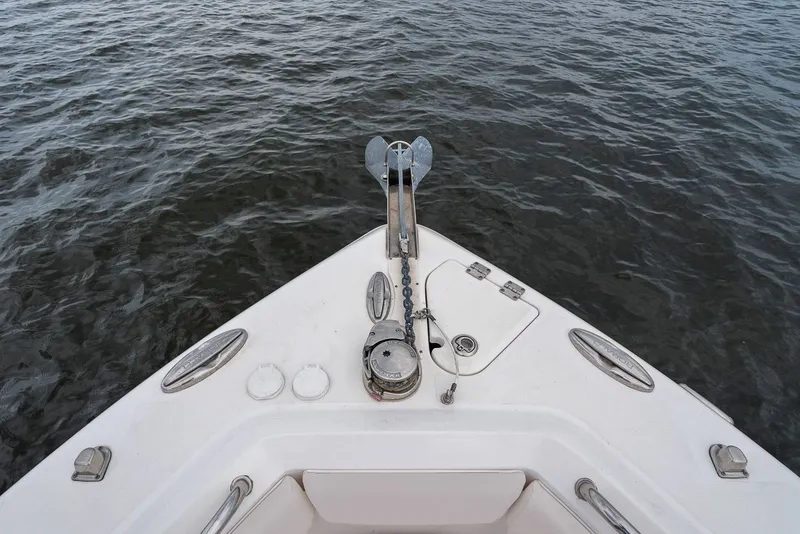 Slide: The Image of Bow of 2013 Robalo R260 Center Console boat on calm water. - 3