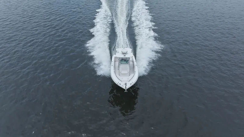 Slide: The Image of 2013 Robalo R260 Center Console cruising on open water. - 30