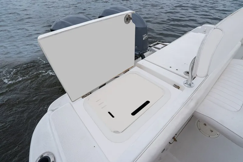 Slide: The Image of 2013 Robalo R260 Center Console with open storage hatch. - 36