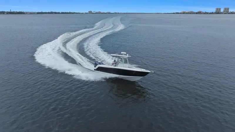 Slide: The Image of 2013 Robalo R260 Center Console cruising on open water. - 40