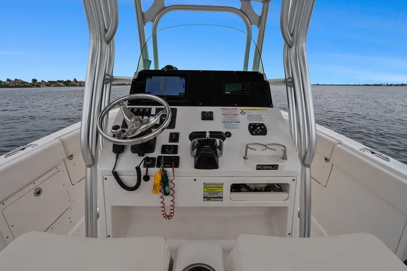 Slide: The Image of Robalo R260 Center Console 2013 helm on open water. - 5
