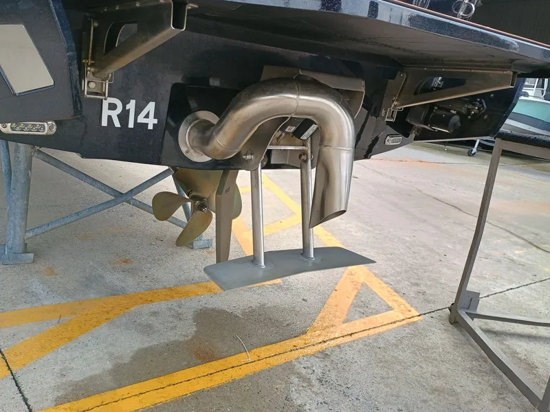 Slide: The Image of Rear view of a 2024 Axis A245 boat with propeller and exhaust. - 8