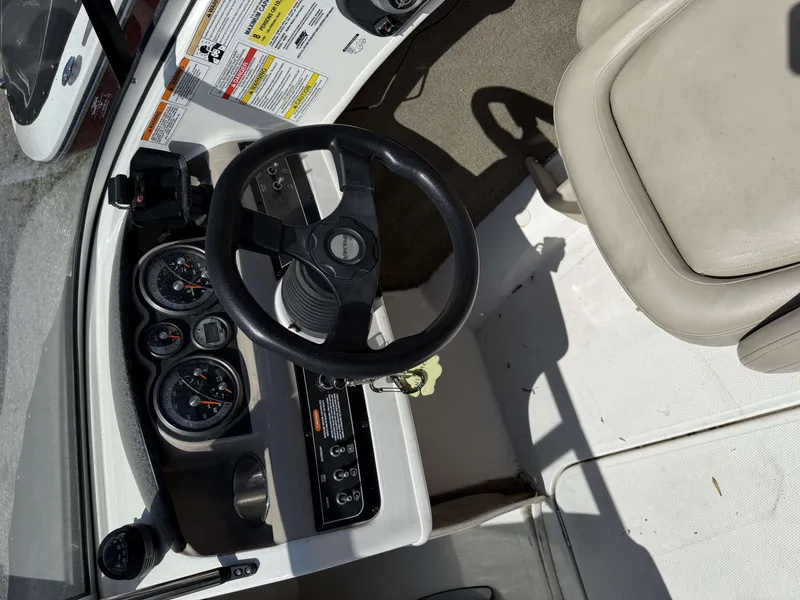 Slide: The Image of Interior of a 2015 Bayliner 185 Bowrider with steering wheel and dashboard. - 5