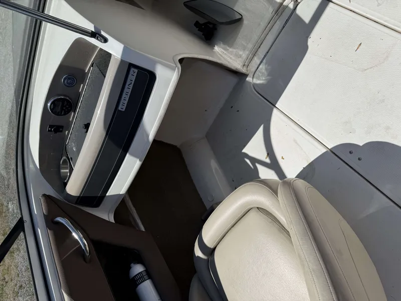 Slide: The Image of Interior of a 2015 Bayliner 185 Bowrider boat, beige seats and dashboard. - 6