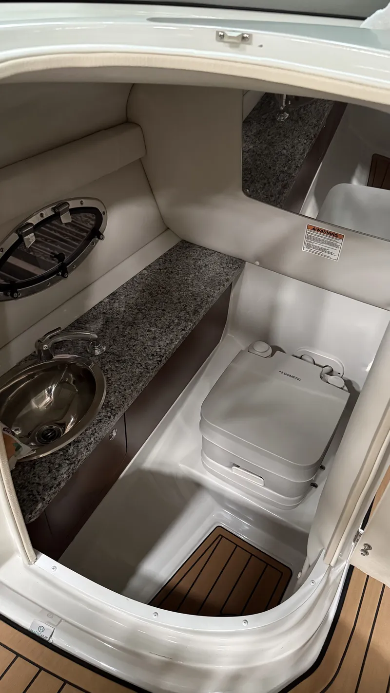 Slide: The Image of Interior of 2022 Crownline Eclipse E255 XS with sink and toilet. - 3