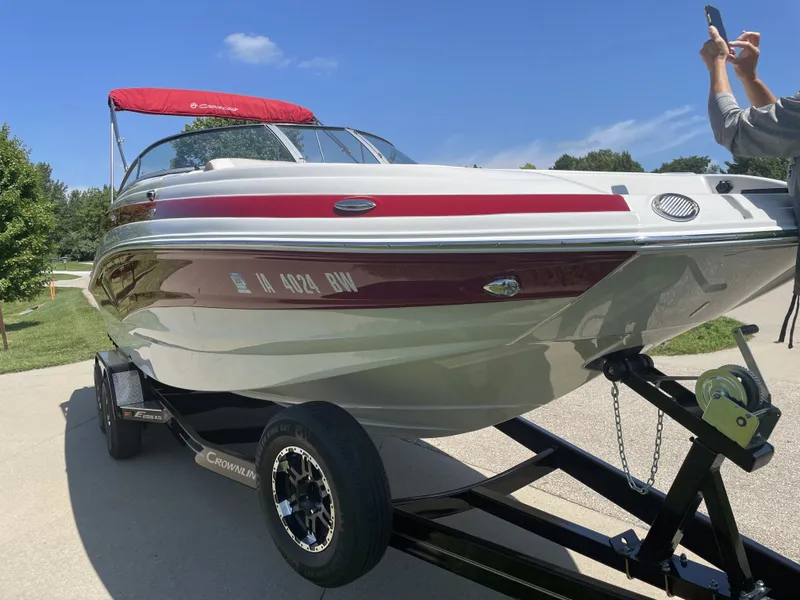Slide: The Image of 2022 Crownline Eclipse E255 XS boat on trailer, red canopy. - 6