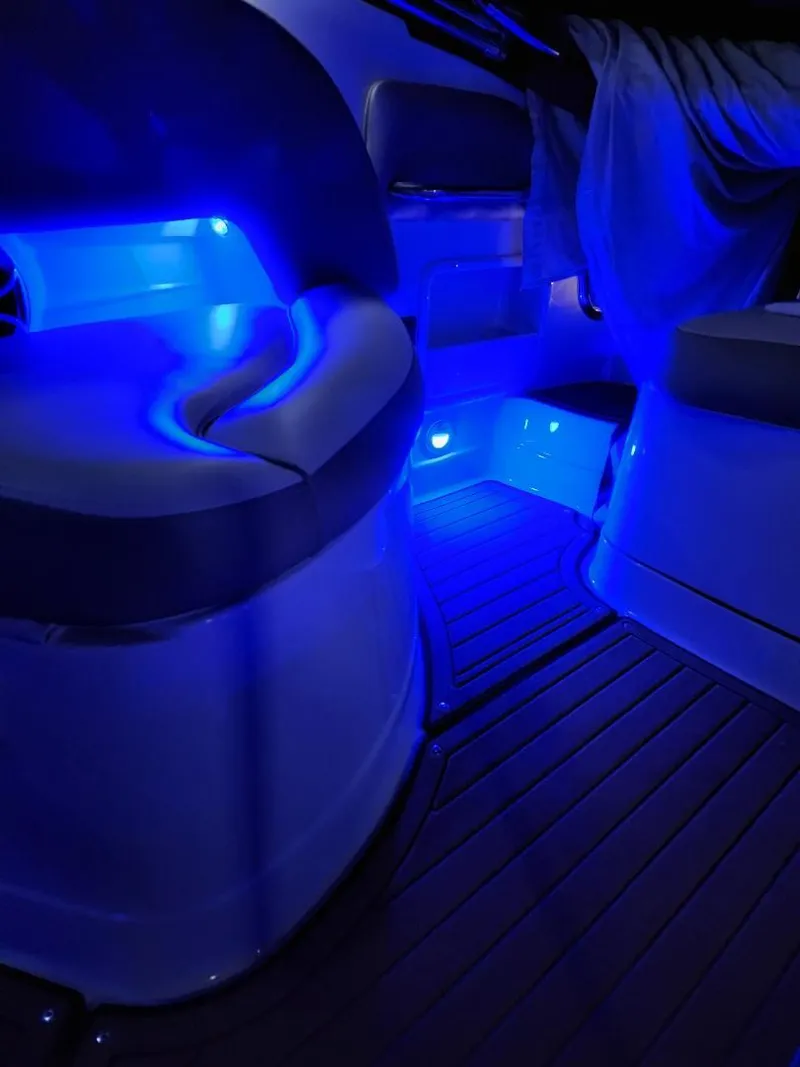 The Image of Interior of 2022 Heritage Trailer CROWNLINE E255XS with blue LED lighting. - 1