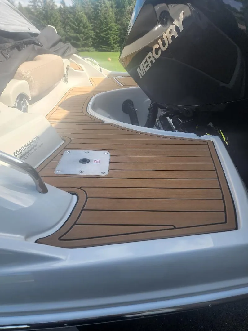 Slide: The Image of 2022 Heritage Trailer CROWNLINE E255XS with Mercury engine, wood deck detail view. - 4