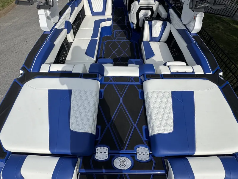 Slide: The Image of Interior of 2025 Malibu M242 with blue and white seating. - 12