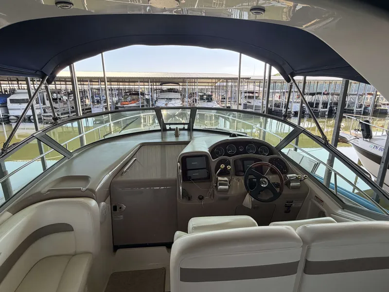 Slide: The Image of Interior view of a 2003 Sea Ray Sundancer 320 cockpit in the marina. - 10