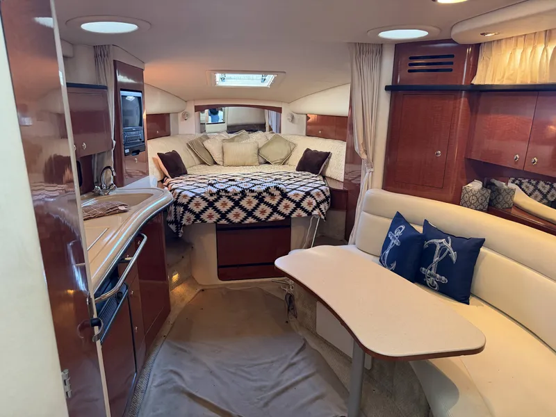 Slide: The Image of Interior of a 2003 Sea Ray Sundancer 320 yacht with cozy bed and seating area. - 11