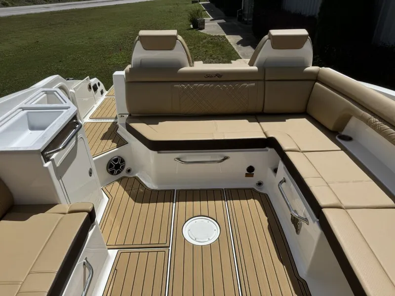 Slide: The Image of Interior of 2026 Sea Ray SDX290 with beige upholstery and wood finish. - 11