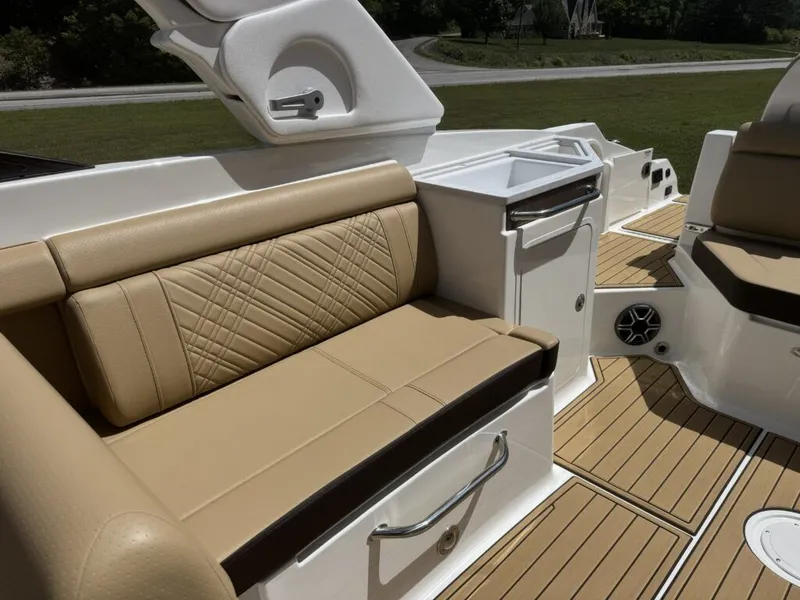 Slide: The Image of Interior of 2026 Sea Ray SDX290 with beige leather seating. - 13