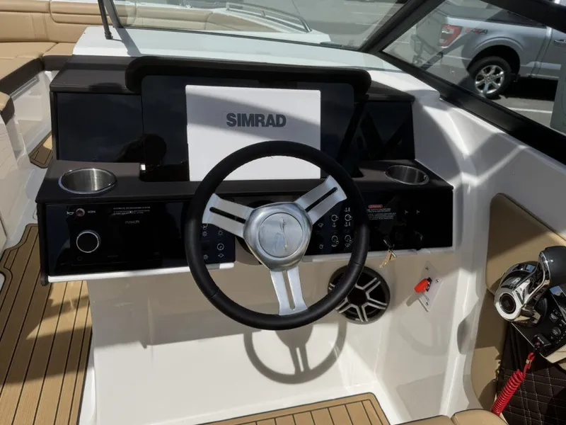 Slide: The Image of 2026 Sea Ray SDX290 helm with Simrad display and controls. - 20