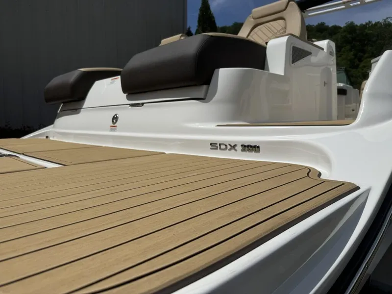 Slide: The Image of 2026 Sea Ray SDX290 boat with wooden deck and luxurious seating. - 29