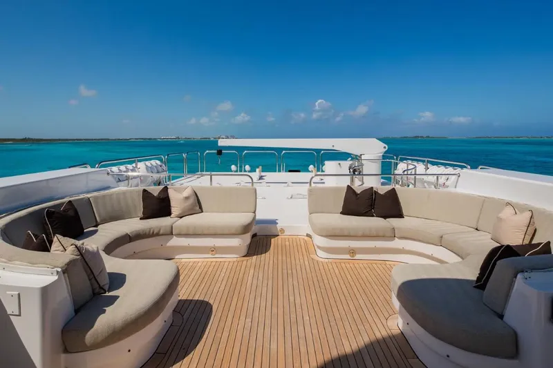 Slide: The Image of Luxurious deck seating on 1988 Van Mill 143 Tri-Deck Motor Yacht, overlooking turquoise waters. - 13