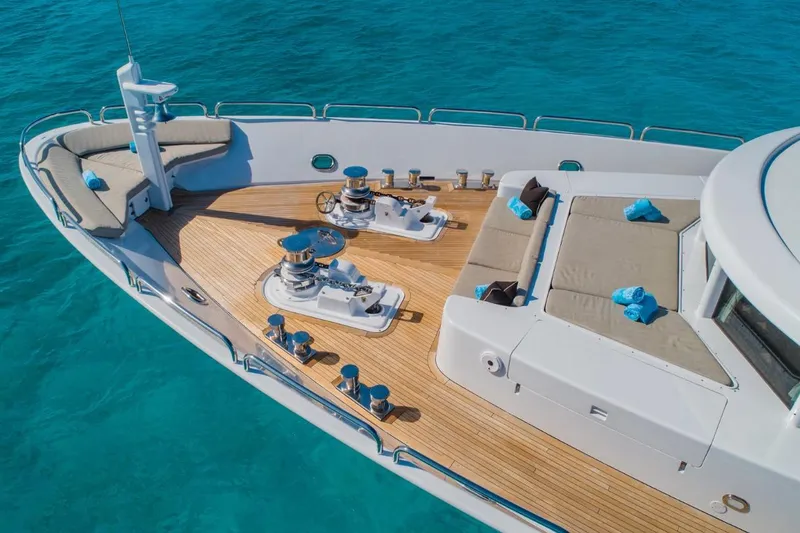 Slide: The Image of Luxurious Van Mill 143 Tri-Deck Motor Yacht deck with seating, 1988 model, on turquoise water. - 17