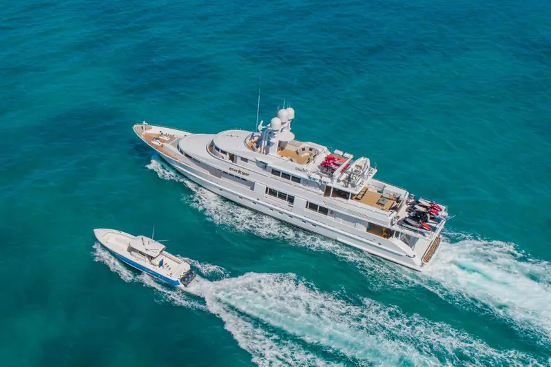 Slide: The Image of Aerial view of 1988 Van Mill 143 Tri-Deck Motor Yacht cruising in clear blue waters. - 2