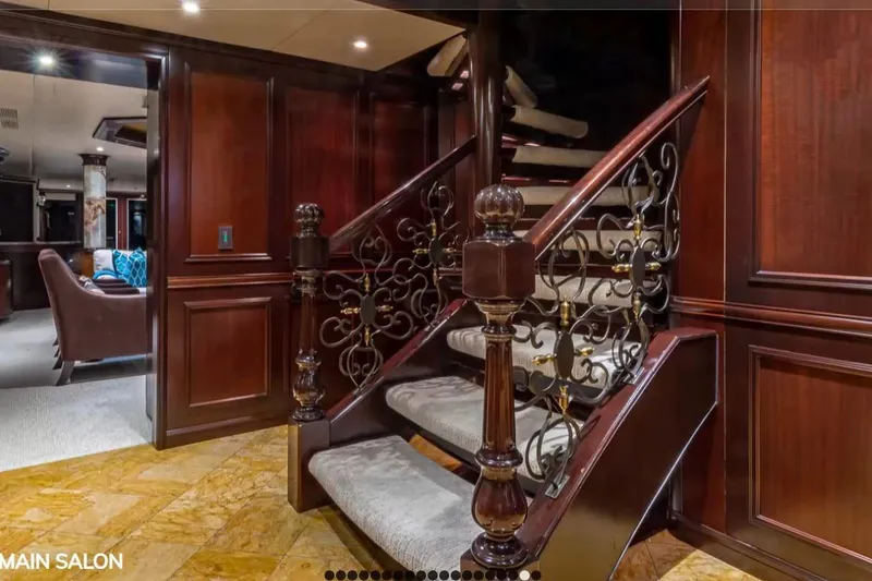 Slide: The Image of Luxurious interior of 1988 Van Mill 143 Tri-Deck Motor Yacht with elegant staircase and wood paneling. - 20