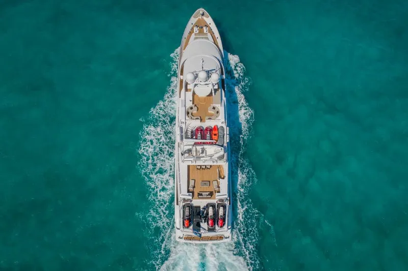 Slide: The Image of Aerial view of 1988 Van Mill 143 Tri-Deck Motor Yacht cruising in turquoise waters. - 3