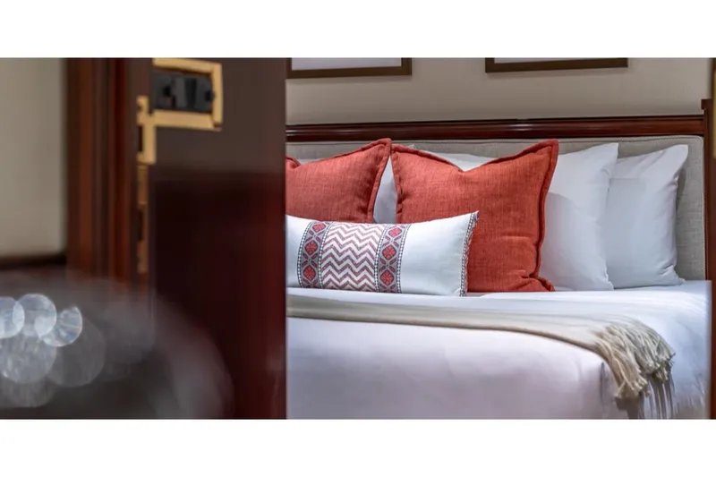 Slide: The Image of Luxurious bedroom interior on 1988 Van Mill 143 Tri-Deck Motor Yacht with elegant pillows. - 34