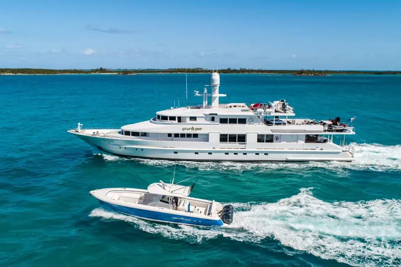 Slide: The Image of Luxurious 1988 Van Mill 143 Tri-Deck Motor Yacht cruising in clear blue waters. - 4