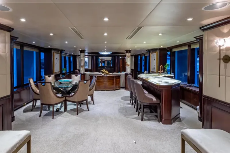 Slide: The Image of Luxurious interior of 1988 Van Mill 143 Tri-Deck Motor Yacht with elegant dining and bar area. - 51