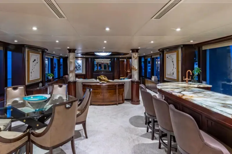 Slide: The Image of Luxurious interior of 1988 Van Mill 143 Tri-Deck Motor Yacht with elegant dining and bar area. - 53