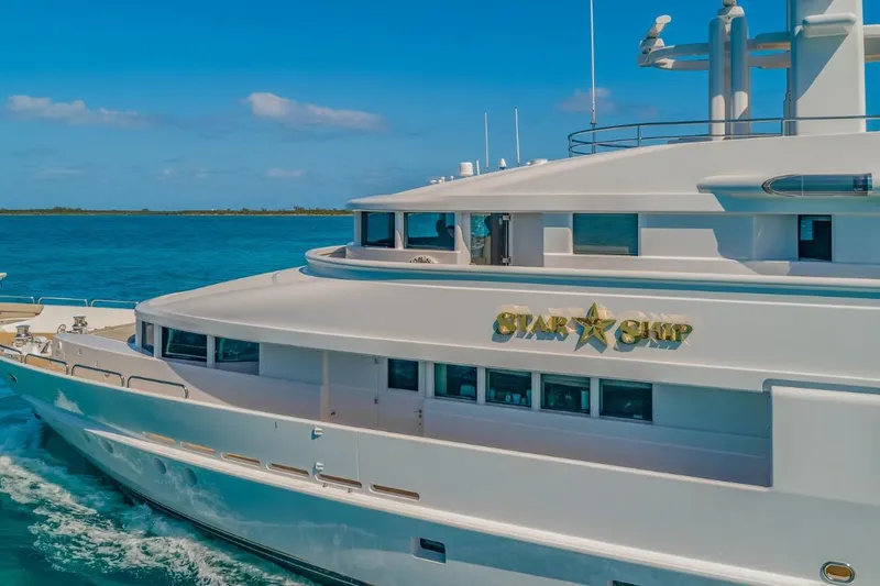 Slide: The Image of Luxurious 1988 Van Mill 143 Tri-Deck Motor Yacht cruising on clear blue waters. - 6